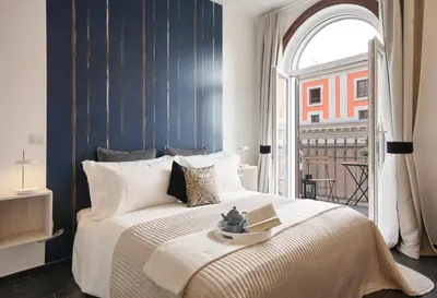 a bedroom with a large bed with a window at Relais Quattro Fontane in Rome