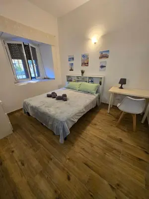 a bedroom with a bed and a desk and a table at Casa in Rome