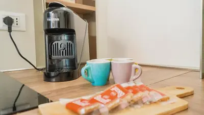 a kitchen counter with two cups and a coffee maker at Aria Charme in Rome