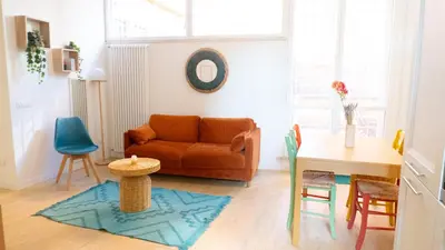 a living room with a couch and a table and chairs at Aria Charme in Rome