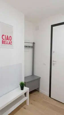a white room with a bench and a closet at Aria Charme in Rome