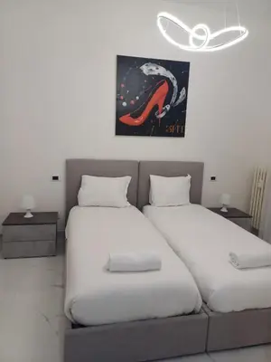 a room with two beds and a couch at 612 Flats in Rome
