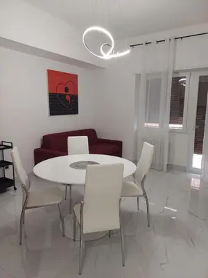a living room with a white table and chairs at 612 Flats in Rome