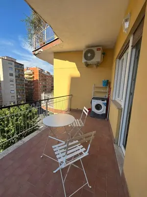 a patio with a table and chairs on a balcony at 612 Flats in Rome