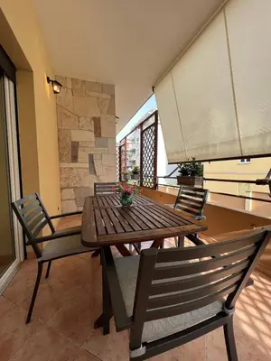 a table and chairs in a room with a stone wall at ARTPA Rome Apartments Gianicolo, Roma in Rome
