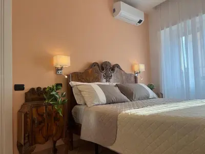 a bedroom with a bed with a wooden headboard at ARTPA Rome Apartments Gianicolo, Roma in Rome