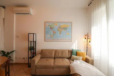 a living room with a couch and a map on the wall at Oasi di relax a Monteverde in Rome