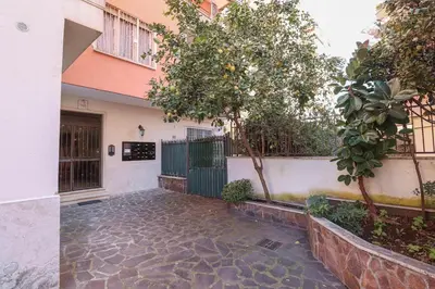 a building with a gate and a tree in front of it at Oasi di relax a Monteverde in Rome