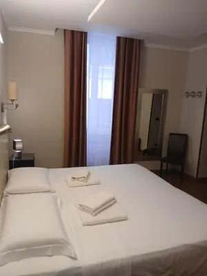 a white bed with two towels on top of it at StefanoHouse Barberini 2 appartamenti in Rome