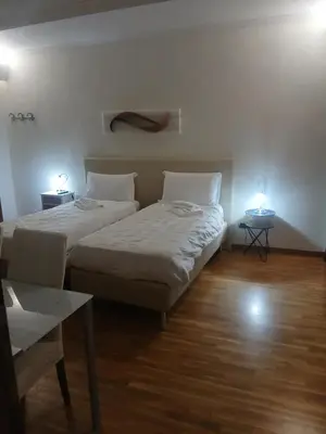 a bedroom with two beds and two tables with lights at StefanoHouse Barberini 2 appartamenti in Rome