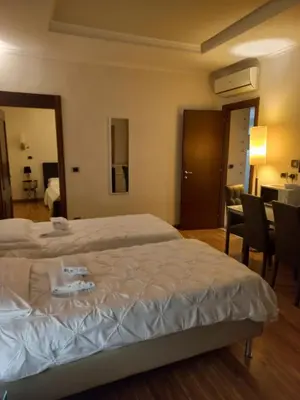 a bedroom with a bed and a table and chairs at StefanoHouse Barberini 2 appartamenti in Rome