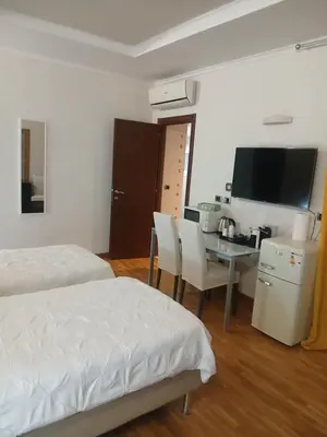 a bedroom with a bed and a desk with a computer at StefanoHouse Barberini 2 appartamenti in Rome