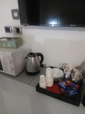 a kitchen counter with a coffee maker and plates and cups at StefanoHouse Barberini 2 appartamenti in Rome