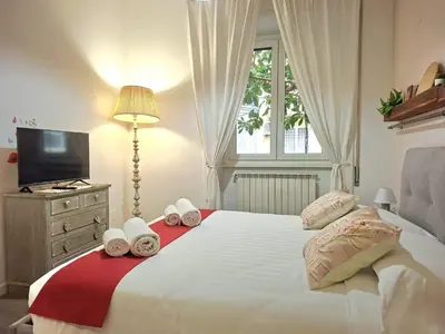a bedroom with a large white bed with towels on it at Melli's R-Home in Rome