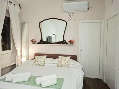 a bedroom with a bed with a mirror on the wall at Melli's R-Home in Rome