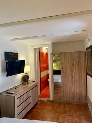 a room with a bedroom with a bed and a television at Vatican Staircase in Rome