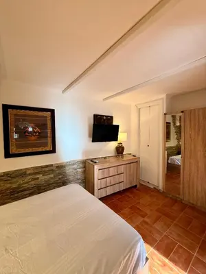 a bedroom with a bed and a tv on a wall at Vatican Staircase in Rome