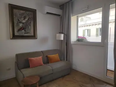 a living room with a couch and a window at Piccola Domus in Rome