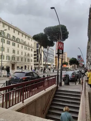 a woman walking down a set of stairs in a city at Piccola Domus in Rome