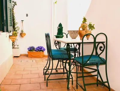 a table with two chairs and a table with plants at A casa di Cicca in Rome