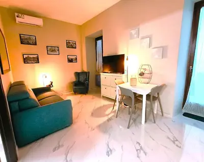 a living room with a couch and a table at A casa di Cicca in Rome