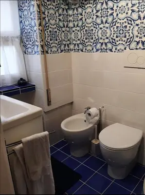 a bathroom with a toilet and a sink and a tub at Diana's Loft in Rome