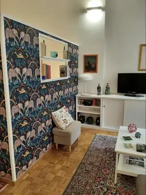 a living room with a wall with a wallpaper at Diana's Loft in Rome