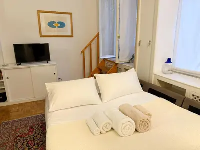 a bedroom with a white bed with towels on it at Diana's Loft in Rome