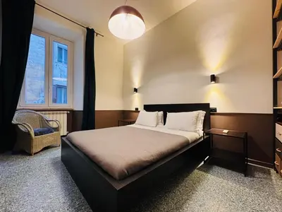 a bedroom with a bed and a chair and a window at Loft Penta - apartment Colosseum in Rome