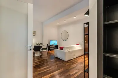 a living room with a white couch and a table at Etiopia Apartment in Rome