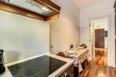 a kitchen with a table and a bath tub at Etiopia Apartment in Rome