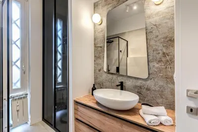 a bathroom with a sink and a mirror at Etiopia Apartment in Rome