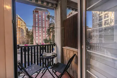 a balcony with two chairs and a small table at Etiopia Apartment in Rome