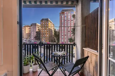 a balcony with a table and chairs on a balcony at Etiopia Apartment in Rome