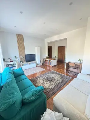 a living room with a blue couch and a tv at 4M Apartment in Rome