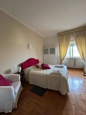 a bedroom with two beds and a couch at 4M Apartment in Rome