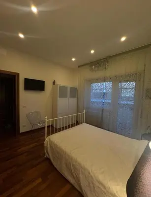 a bedroom with a large bed and a window at 4M Apartment in Rome