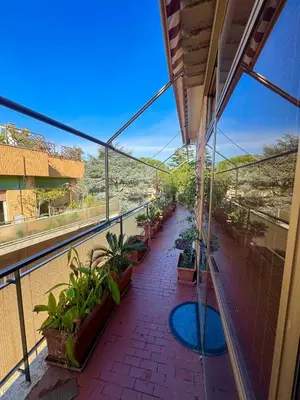 a balcony with potted plants in a building at 4M Apartment in Rome