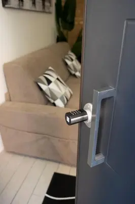a door handle with a couch in a living room at Maison Monteverde, Trastevere in Rome