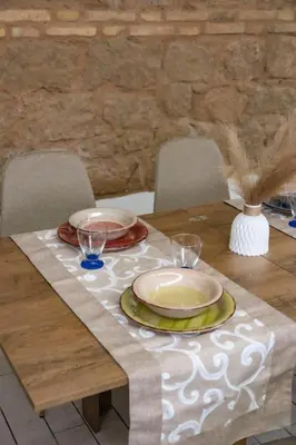 a wooden table with plates and glasses on it at Maison Monteverde, Trastevere in Rome