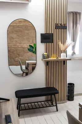 a mirror in a room with a bench and a table at Maison Monteverde, Trastevere in Rome