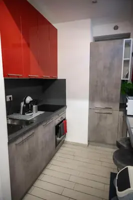 a kitchen with red cabinets and a sink at Maison Monteverde, Trastevere in Rome