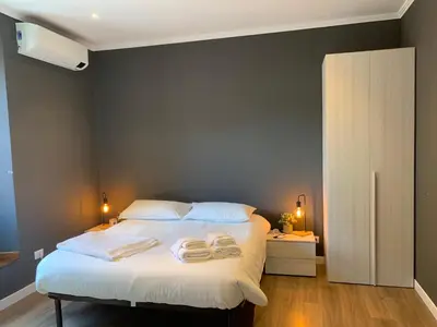 a bedroom with a bed with two towels on it at San Lorenzo Elegance Suites - just steps from the Colosseum in Rome