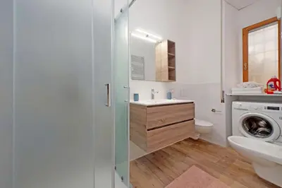 a bathroom with a sink and a washing machine at Monica's house in Rome