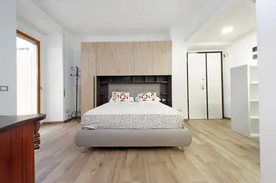 a bedroom with a bed with two pillows on it at Monica's house in Rome
