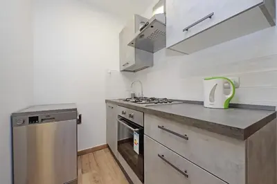 a small kitchen with a stove and a sink at Monica's house in Rome