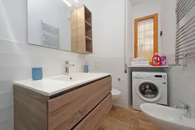 a bathroom with a sink and a washing machine at Monica's house in Rome