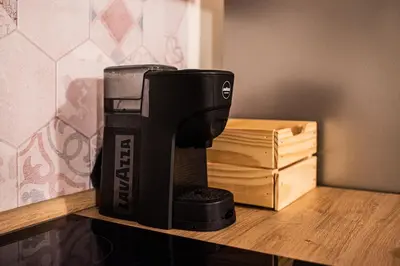 a coffee maker sitting on a shelf next to a box at Lusitiny Apartment in Rome