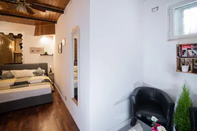 a small room with a bed and a chair at Lusitiny Apartment in Rome