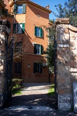 an orange building with a gate in front of it at Lusitiny Apartment in Rome